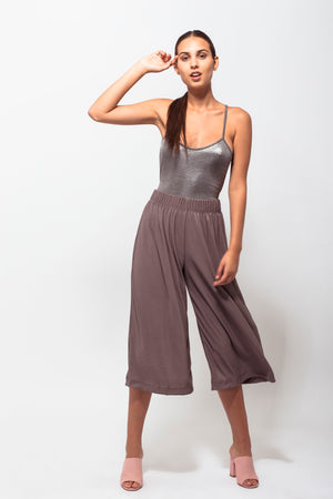 Metallic squared neck bodysuit with a crisscross open back. Pair it with some loose pants and sandals!