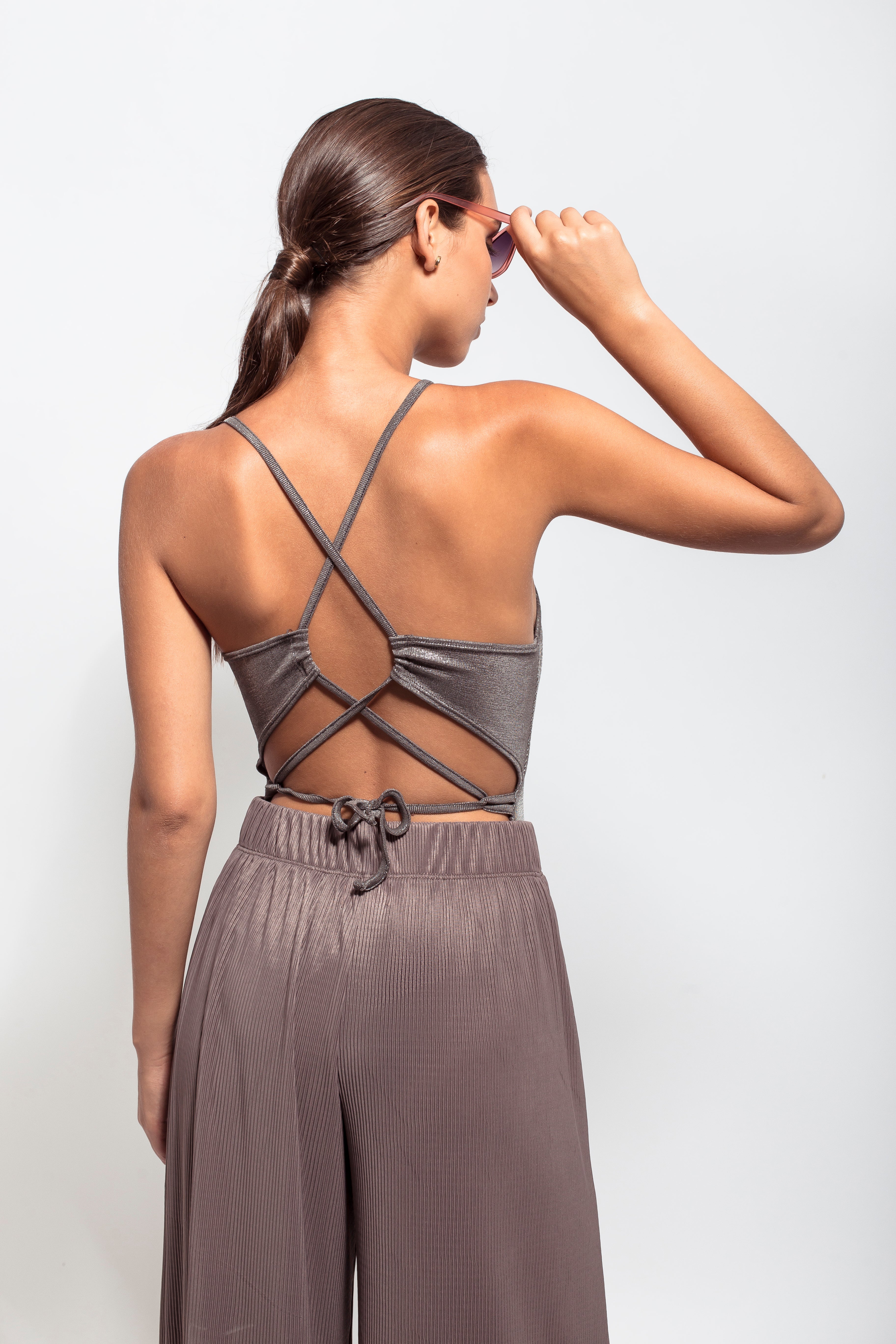 Metallic squared neck bodysuit with a crisscross open back. Pair it with some loose pants and sandals!